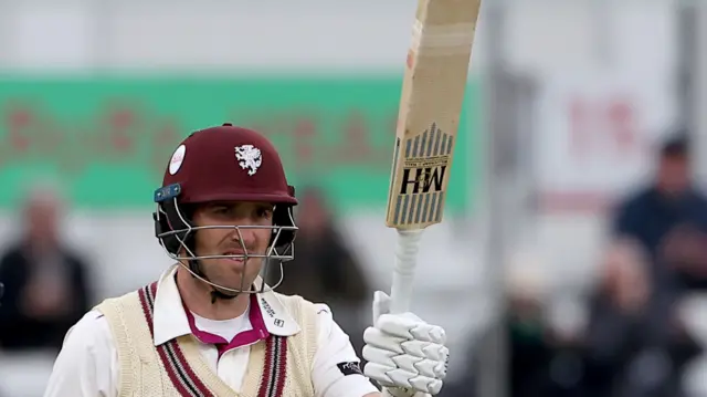 Craig Overton raising his bat upon reaching 50 for Somerset