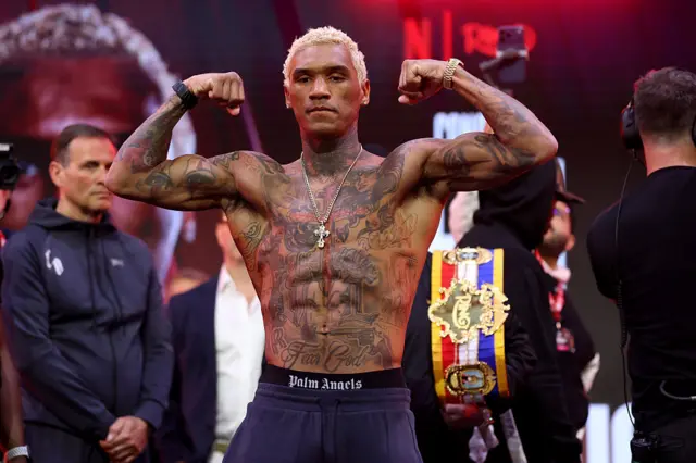 Conor Benn flexes his muscles as he weighs in