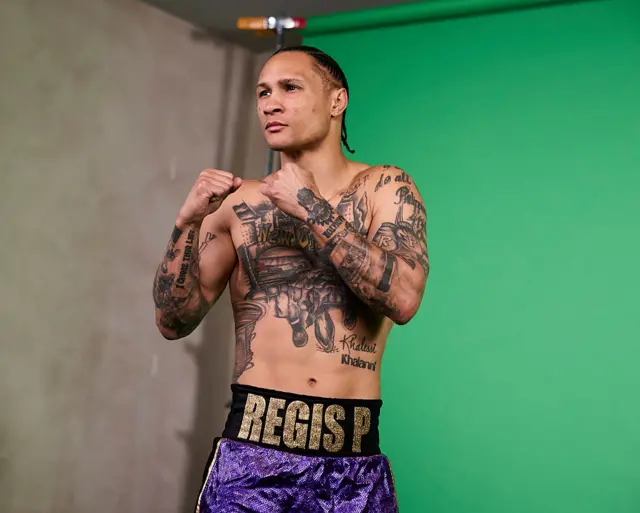 Regis Prograis is shirtless and holding up his fists