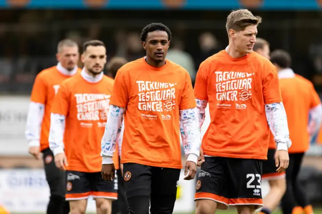 Dundee United players warm up at Tannadice