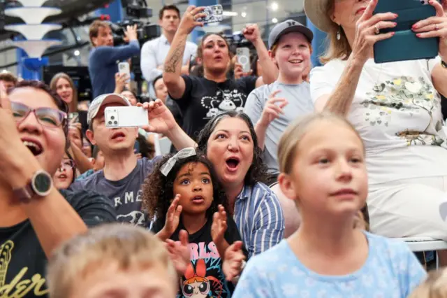 Crowds cheer and film as the Artemis II mission returns