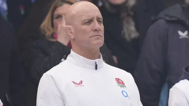 John Mitchell stands during the national anthem