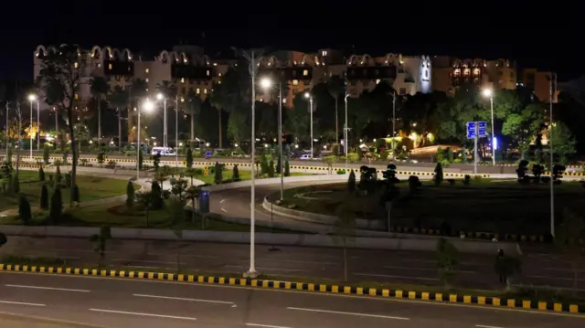 The Serena hotel stands in the background as U.S. and Iran hold peace talks in Islamabad.