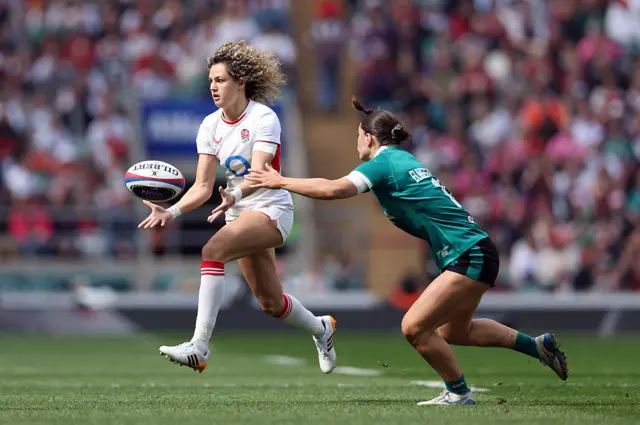 Ellie Kildunne of England breaks with the ball while under pressure from Vicky Elmes Kinlan of Ireland
