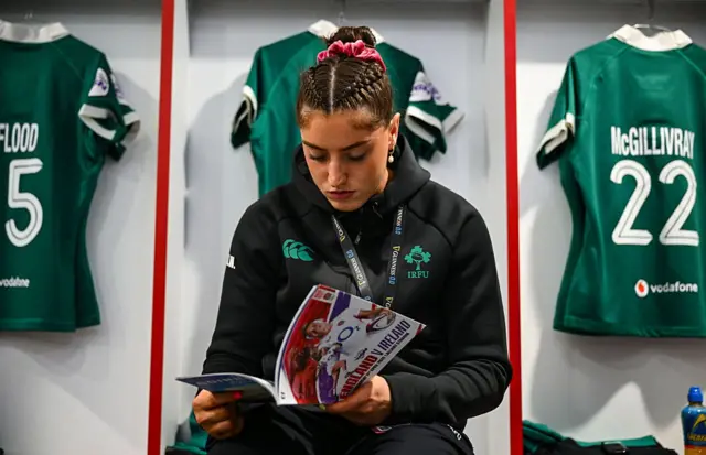 Erin King reading the match programme