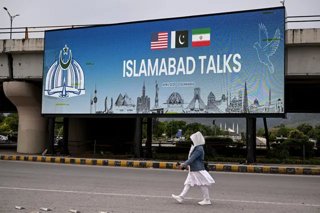 Digital billboards reading "ISLAMABAD TALKS" can be seen on the streets of the capital, with flags from the US and Iran, with Pakistan's emblem sitting between them