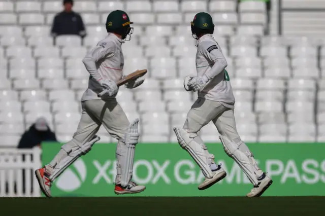 Rishi Patel and Ian Holland running between the wickets for Leicestershire