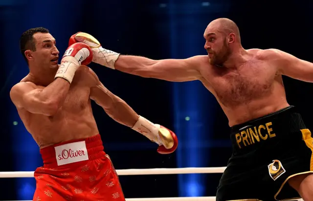 Tyson Fury throws a punch at Wladimir Klitschko