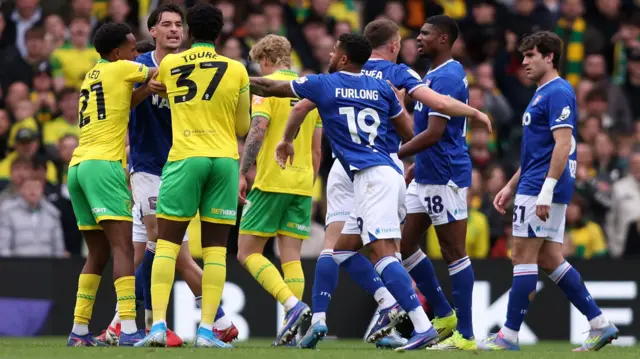 Norwich and Ipswich players clash