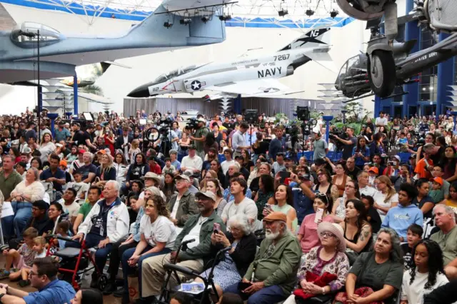 A picture showing crowds gathered at the San Diego Air and Space Museum to watch the return