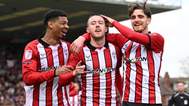 Jack Moylan celebrates his goal with Lincoln City team-mates