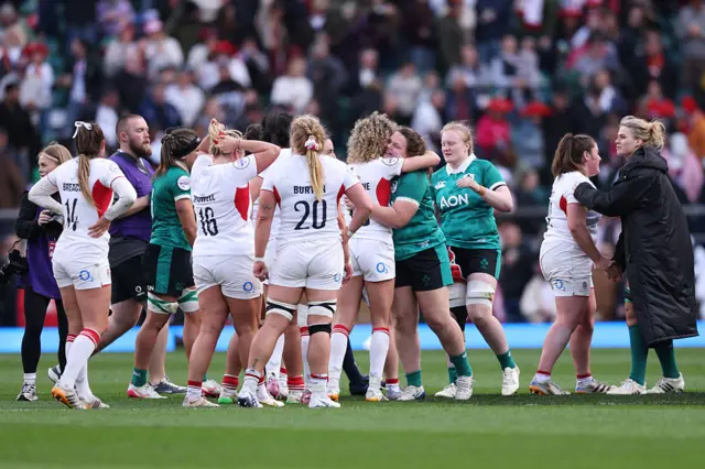Players of England are congratulated by players of Ireland following victory