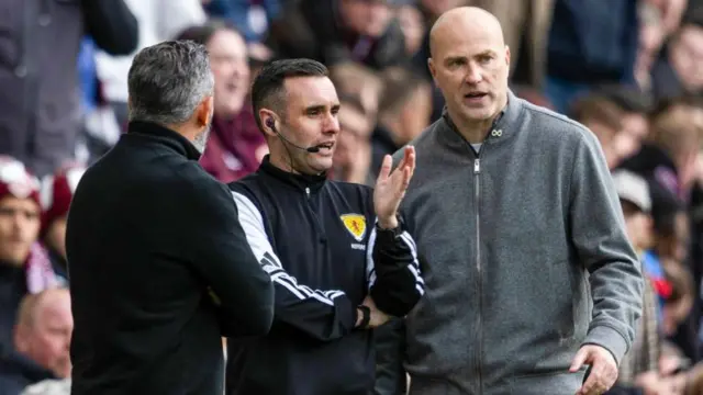 Motherwell's Jens Berthel Askou (right) talks to the fourth official