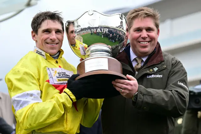 Harry and Dan Skelton holding a trophy at Cheltenham in 2024