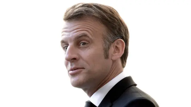 French President Emmanuel Macron, a middle-aged man in a suit.