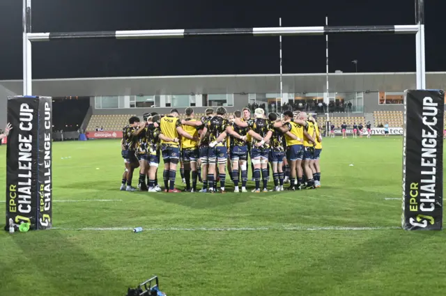Dragons players in a huddle pre-match