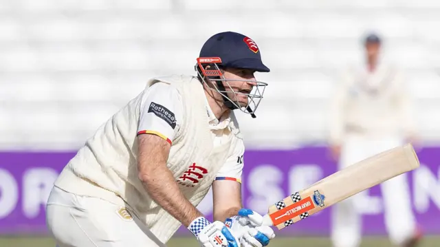 Paul Walter stooping forward holding his bat in both hands