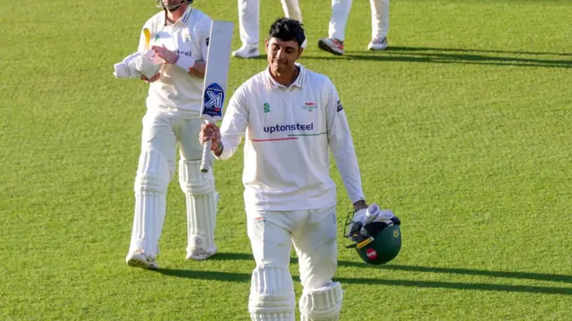 Rishi Patel raises his bat at the end of day two for Leics at Surrey