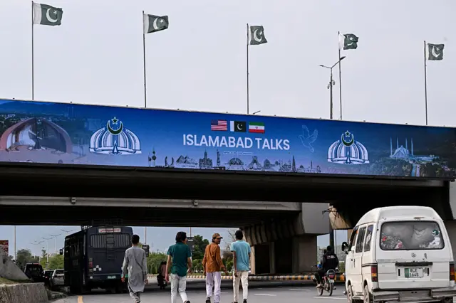 Digital billboards reading "ISLAMABAD TALKS" can be seen on the streets of the capital, with flags from the US and Iran, with Pakistan's emblem sitting between them