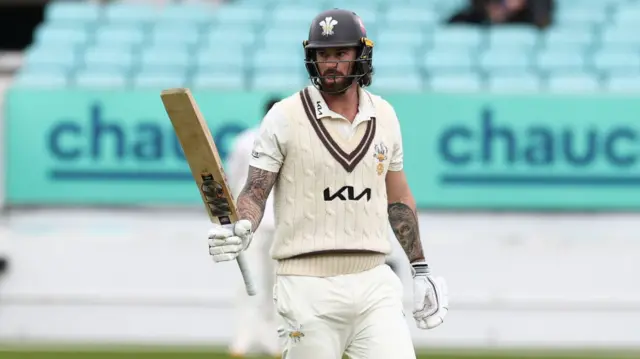 Jordan Clark raises his bat for 50