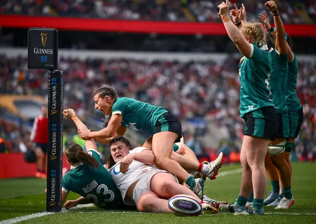 Ireland players celebrate their side's first try, scored by Anna McGann