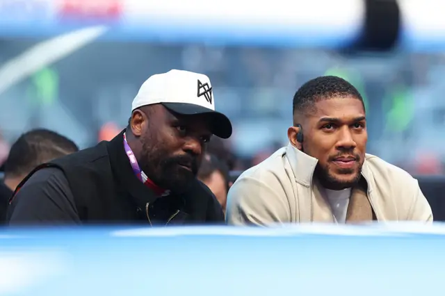 Derek Chisora and Anthony Joshua sit ringside