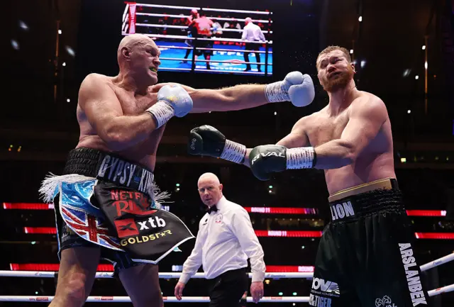 Tyson Fury lands a punch on Arslanbek Makhmudov