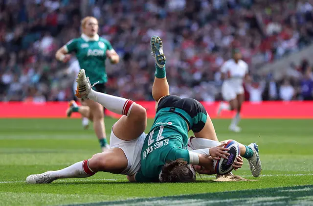 Jess Breach of England scores her team's fourth try whilst being tackled by Vicky Elmes Kinlan of Ireland