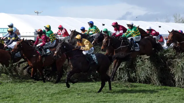 Horses jumping during the Grand National