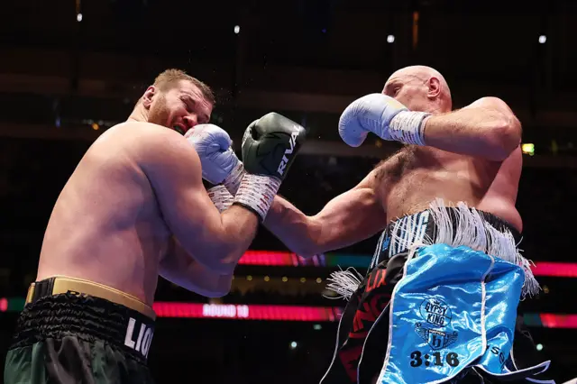 Tyson Fury lands a punch on Arslanbek Makhmudov
