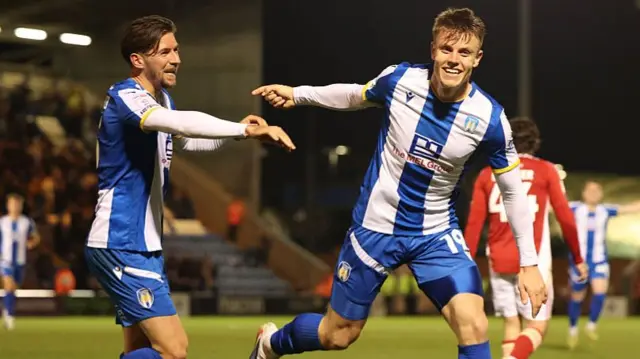 Will Goodwin of Colchester United (right) celebrates after scoring against Swindon Town