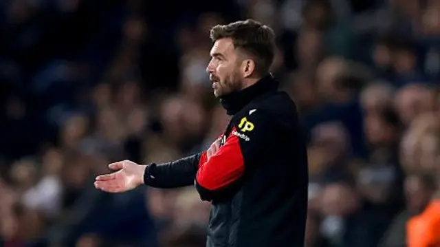 James Morrison with his hand extended on the West Brom sideline