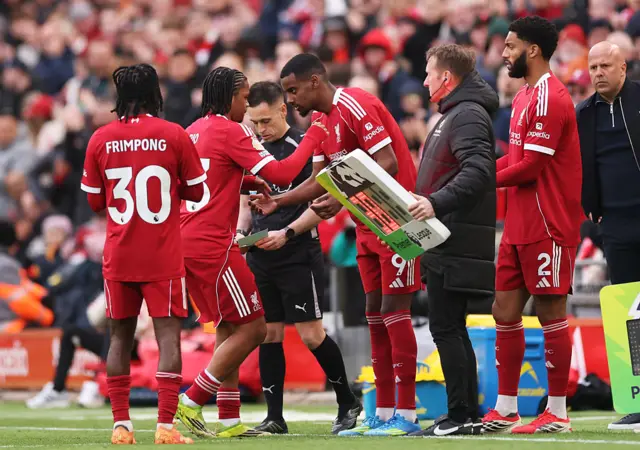 Alexander Isak and Joe Gomez of Liverpool are substituted on for team mates Rio Ngumoha and Jeremie Frimpong
