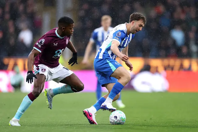 Jack Hinshelwood of Brighton & Hove Albion is challenged by Florentino Luis of Burnley