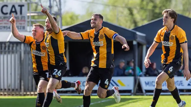 James Gibbons and teammates celebrate Cambridge's fourth goal