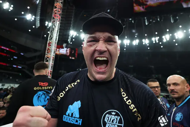 Tyson Fury holds up his fists and screams