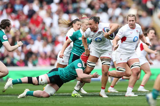 Maddie Feaunati of England is tackled by Aoife Wafer of Ireland