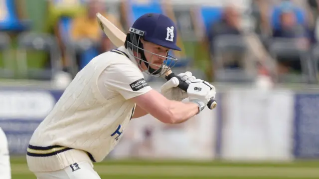 Rob Yates watchfully leaving a ball with his bat above his body