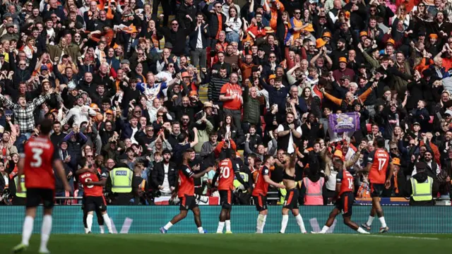 Luton celebrate scoring third goal