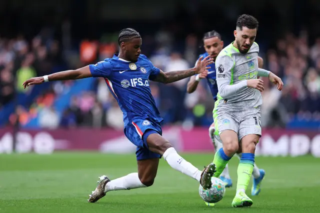 Rayan Cherki of Manchester City is challenged by Jorrel Hato of Chelsea