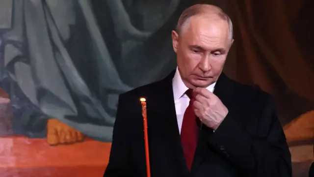 Vladimir Putin holding a candle