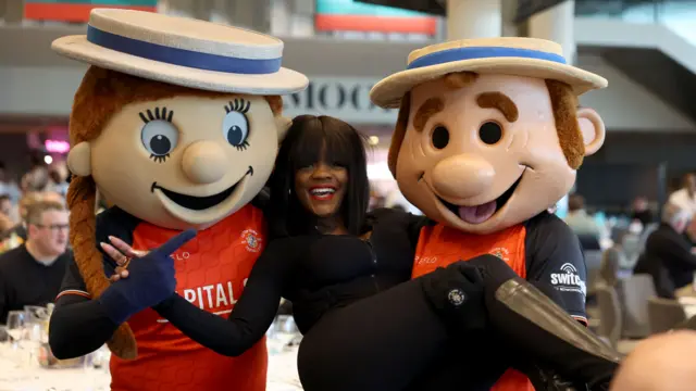 Luton Town mascots carrying a woman