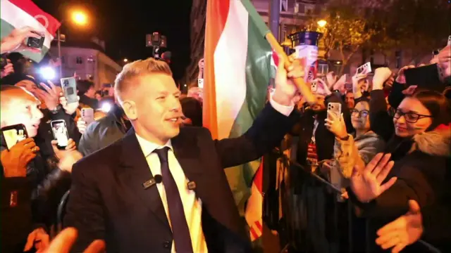 Peter Magyar waving a Hungarian flag
