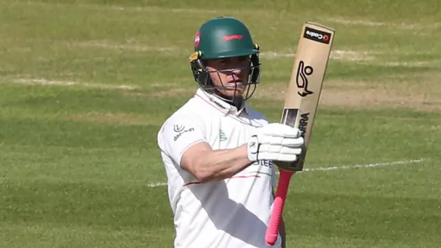 Leicestershire's Ben Cox raises his bat