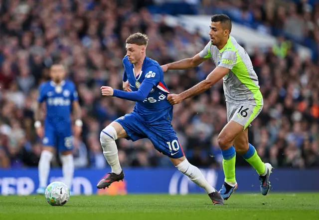 Cole Palmer of Chelsea is challenged by Rodri
