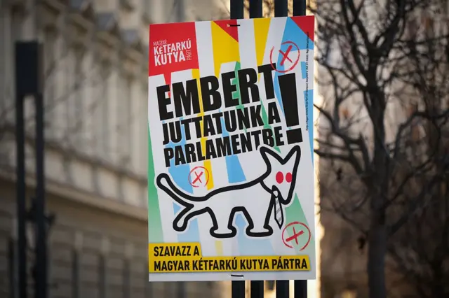 A Hungarian election poster showing a cartoon of a dog with two tails wearing a tie