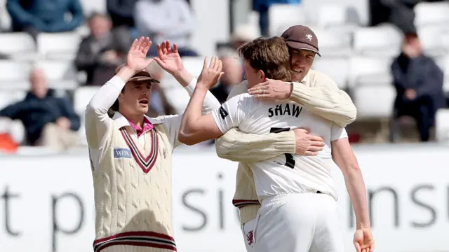 Josh Shaw is hugged by Craig Overton and prepares to high-five Tom Abell