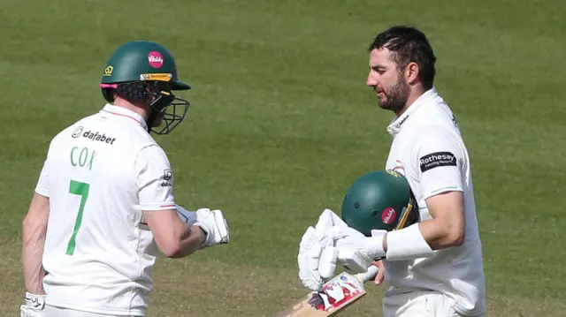 Ben Cox (left) about to punch gloves with Stephen Eskinazi (who is holding his helmet) at The Oval