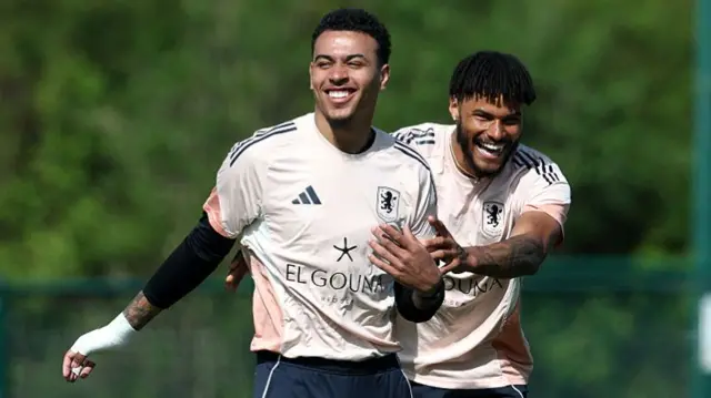 Morgan Rogers and Tyrone Mings of Aston Villa react during a training session