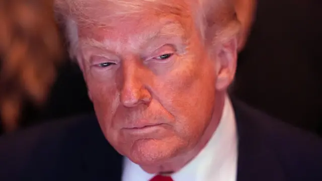 A close-up of Donald Trump, with his head and shoulders visible.